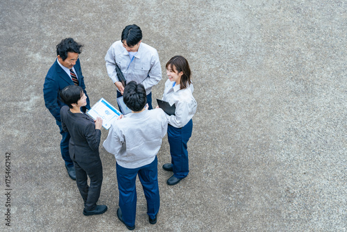 屋外に集まって話し合う会社従業員のグループ