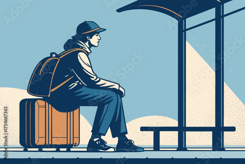 A person in a hat and backpack sits on a suitcase at a bus stop.