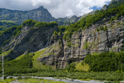 This landscape photo was taken in Europe, France, Auvergne-Rhone-Alpes, Haute-Savoie, Sixt-Fer-a-Cheval, in summer. It shows the hiking trail in the mountains of the Cirque du Fer-a-Cheval
