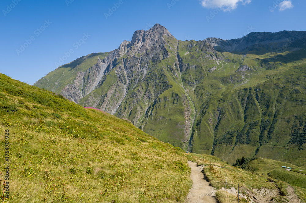 Naklejka premium This landscape photo was taken in Europe, France, Aosta Valley, in summer. It shows the hiking path between the mountains, under the Sun.