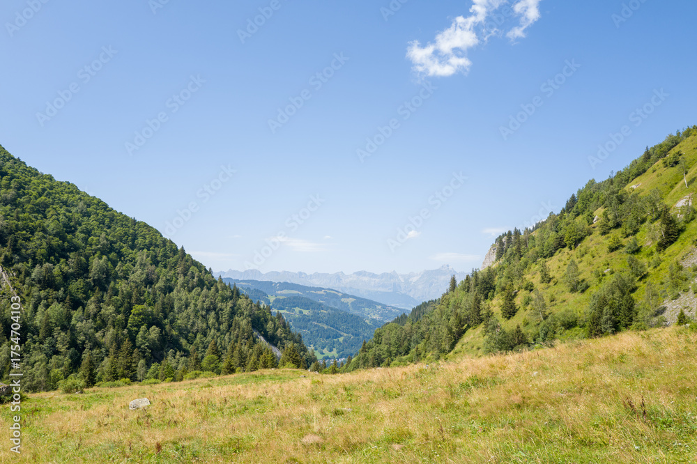 Obraz premium This landscape photo was taken in Europe, France, Auvergne Rhone Alpes, Haute Savoie, in summer. We can see the mountains, under the Sun.