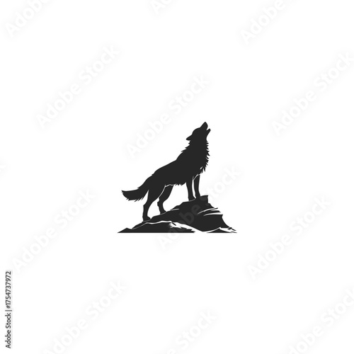 Majestic howling wolf silhouette stands on a rocky outcrop, symbolizing wilderness, freedom, strength, and wild nature spirit.