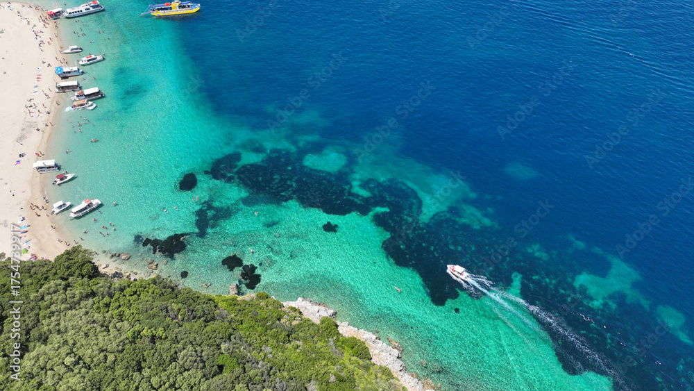 Fototapeta premium Aerial drone photo of famous steep rocky white cliffs creating beautiful coves and turquiose sea caves of Kampi visited by small boats and yachts in northern part of Zakinthos island, Ionian, Greece