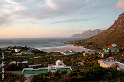 An African coastal town at dusk with distant mountains