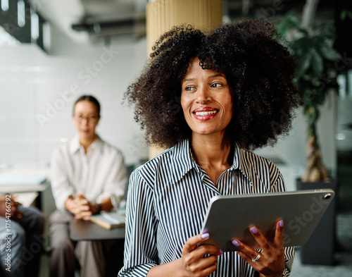 Portrait of a smart young businesswoman using a tablet computer in the office or classroom. Startup and succesful business concept or education and student concept
