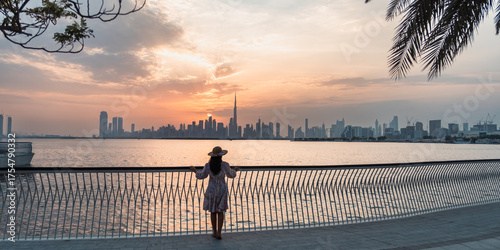 panorama view of Dubai Downtown skyline with creek harbor view at sunset, 4k background wallpaper 	