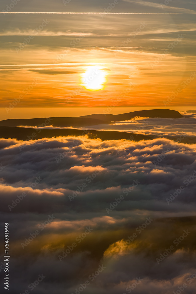 Fototapeta premium Atmospheric mountain landscape with a spectacular cloud inversion at sunset