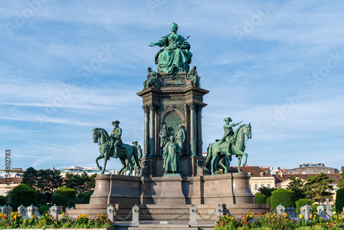Bronze Monument with Equestrian Statues and Classical Sculptures under Blue Sky