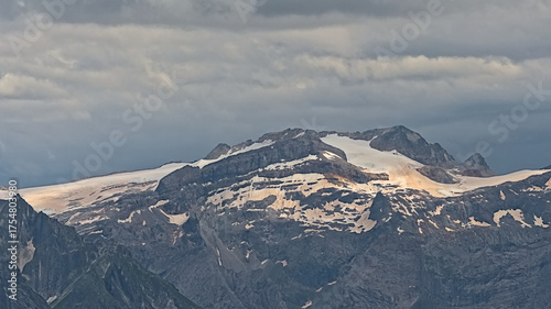 granite mountain peaks with glaciers under a dark stormy sky n La Vanoise national park, Savoie, France 