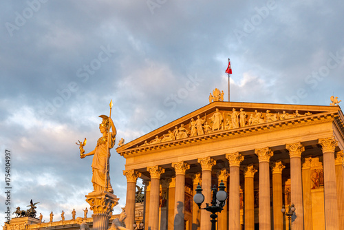 Historic Classical Building with Statue in Golden Dawn Light and Soft Morning Sky