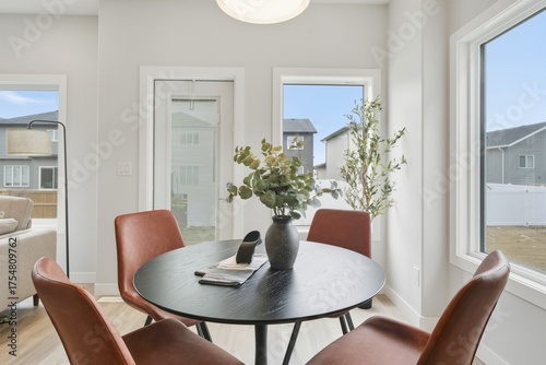 Table with four chairs and a vase of flowers in the center