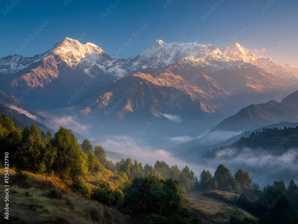 Obraz premium Majestic snow capped mountains bathed in golden sunrise light with mist filling the valleys below