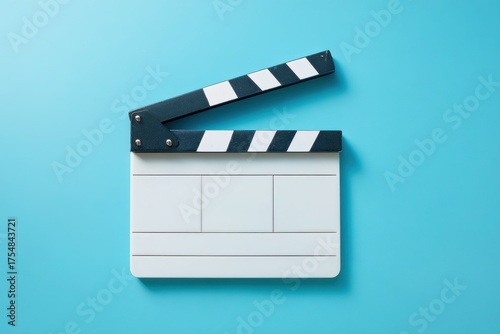 Stylish White Clapboard on Turquoise Backdrop: Minimalist Filmmaking Concept in Cinematography