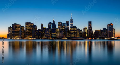 Vibrant new york city skyline at dusk with colorful reflections on water