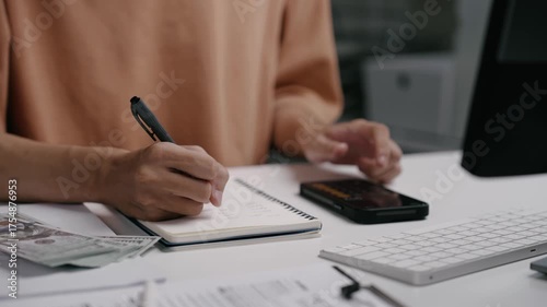Wallpaper Mural Close up man hand using calculator to calculate home finance and writing note, accounting on table, budget management. Doing finance, budgeting and tax calculation, monthly expenses Torontodigital.ca