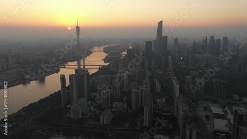 Beautiful drone flight over downtown Guangzhou city at sunset, with residential flats, office towers, and other commercial buildings