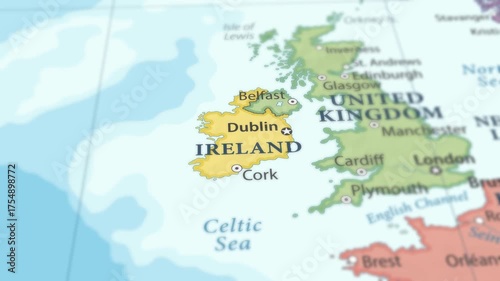 4K macro footage of Ireland on a world map with shallow depth of field. Focus on word Ireland and nearby regions. Travel geography footage