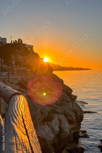 Sunrise over the sea in Rincón de la Victoria, Malaga, Spain, with golden light reflecting on calm waves along the coast.