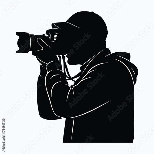 Photographer with camera capturing a moment in striking black silhouette