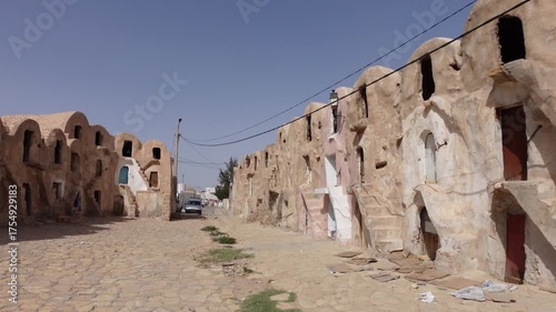 Walking through neglected historic ksar complex (partly used as a storage facility for the local bazaar) in city of Medenine, Tunisia
