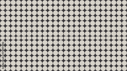 A repetitive pattern of white circles arranged against a dark background in a uniform grid like design