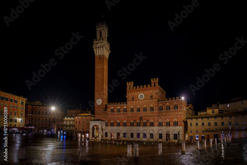 Siena’s Piazza del Campo and Palazzo Pubblico, night view with wet square