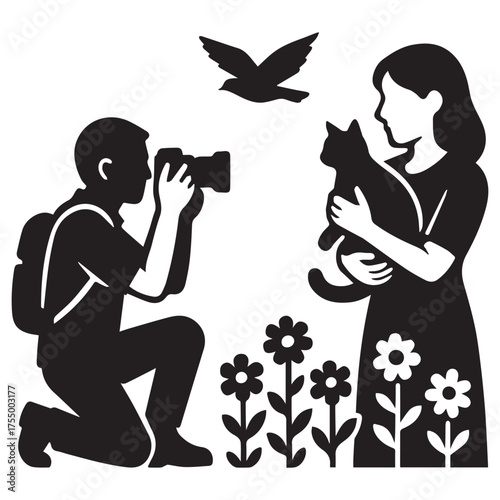 Silhouette of a photographer kneeling to capture a moment of a woman holding a cat with a bird flying overhead and flowers below