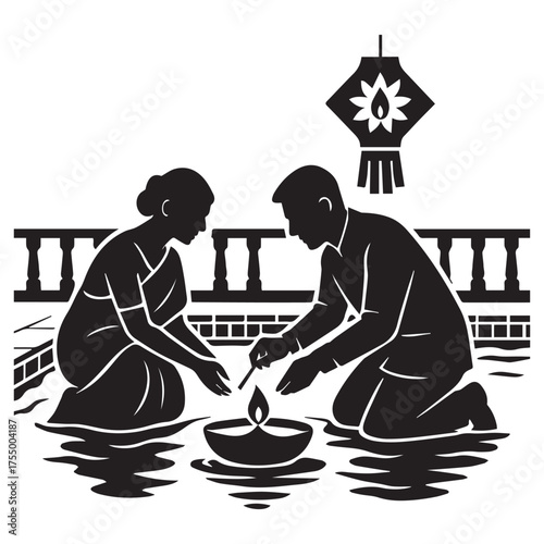 Traditional indian couple kneeling together lighting a diya oil lamp during a festival celebration with a decorative lantern overhead