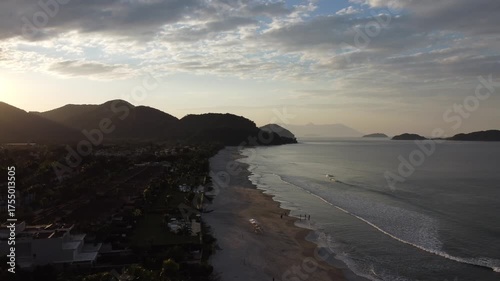 Beautiful sunrise on a tropical paradise beach with small waves in Juquehy