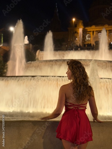 young woman in red dress near a fountain