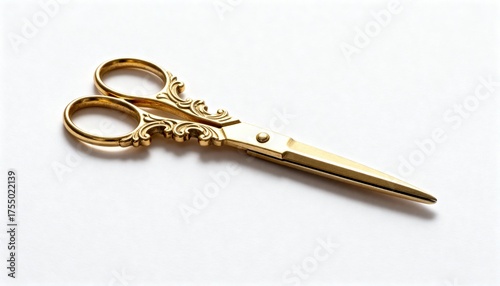 Elegant golden scissors with intricate ornate handles on a clean white background.