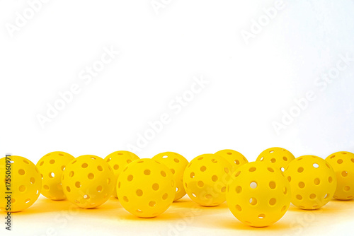Yellow Pickleballs on a white background.  Lots of room for text.