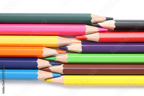 Many colorful pencils on wh...