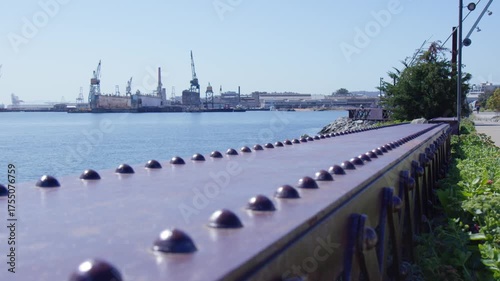 Waterfront View of Industrial City Skyline and Metal Railings