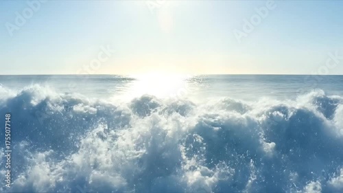 Ocean wave breaking in sunlight with blue water and white foam