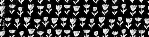 Seamless childish draw style floral vector design with tulips or bells flower motifs. Simple white stem strokes in wax, charcoal, and chalk flourish across a board-like dark background, hand-drawn.