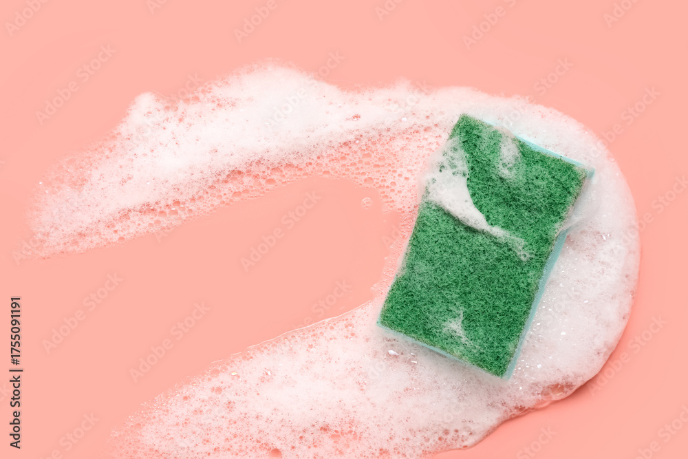 Fototapeta premium Cleaning sponge with foam on pink background