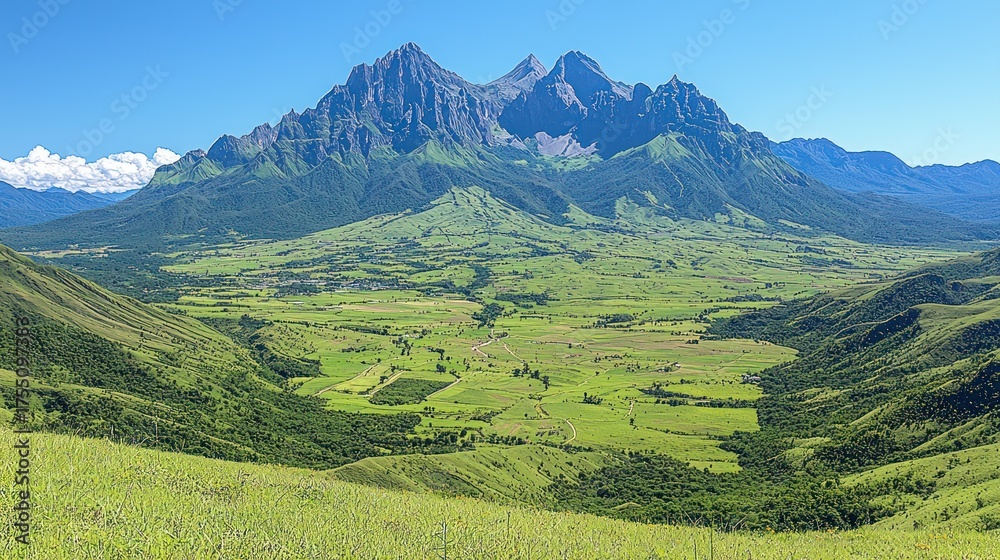 Obraz premium Panoramic view showcasing a majestic mountain range, fertile valley, and vast blue sky