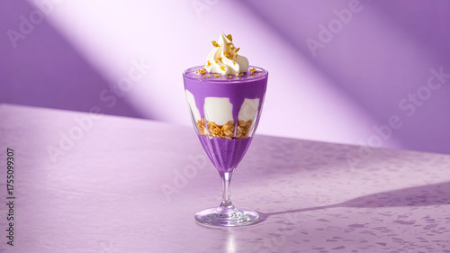 Vibrant purple parfait layered with vanilla cream and granola rests in clear stem glass. Glossy, indulgent treat showcased against soft purple backdrop evokes luxury, creativity, dessert artistry.