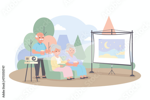 Happy seniors watching an outdoor movie with popcorn enjoying leisure time and entertainment