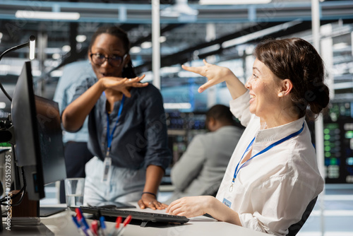 Happy data center colleagues in good mood after after successfully improving system efficiency metrics. Excited engineering team pleased by enhanced network infrastructure performance