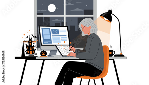 Focused female designer works on digital project at night with Halloween desk decorations