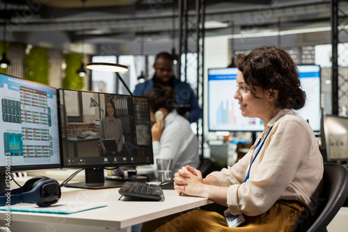 Businesswoman participates at web chat event with a shareholder, sharing insight on performance metrics for a briefing. Video conferencing in the office between business associates.