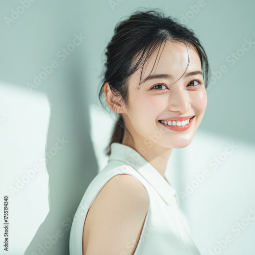 笑顔できらめく綺麗な肌と白い歯を見せる日本人女性美人モデルの接写写真。オーラルケア、スキンケア、コスメ広告用。