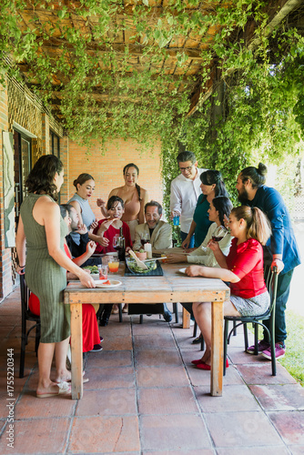 large group of friends or multi generation family eating and having a dinner in a terrace party in Mexico Latin America, hispanic diverse and multicultural people in a restaurant