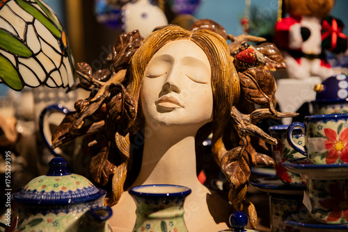 Close-up of beautiful nature woman goddess sculpture in shop display. Ceramic art statue of woman