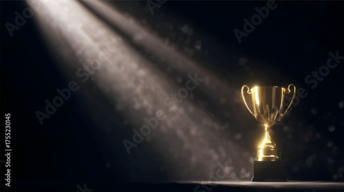 A shiny golden trophy illuminated by beams of light against a dark background