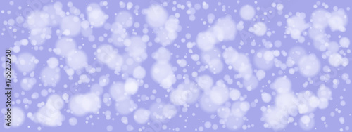 Soft white bokeh lights on a gentle lavender purple background creating a dreamy abstract winter holiday atmosphere