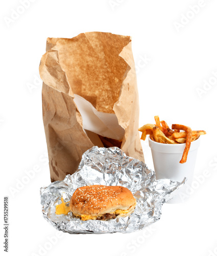 Cheeseburger, french fries in a cup, and torn paper bag on a transparent background.