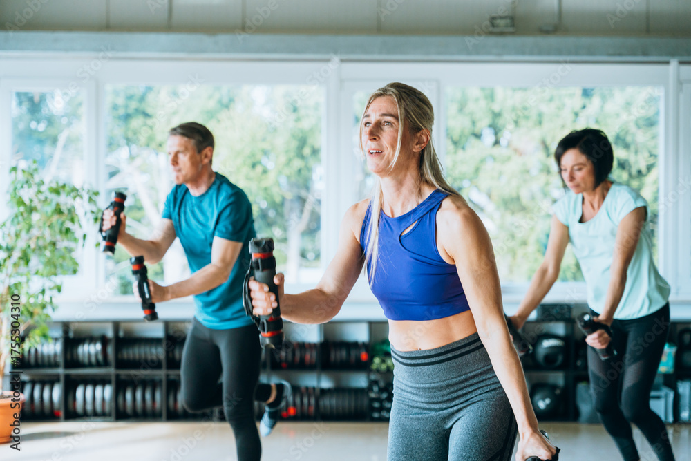 Fototapeta premium Gym workout with group of motivated people doing yoga and sport exercises for health fitness teamwork strength and positive energy